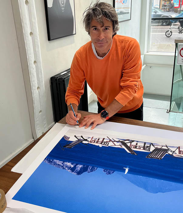Adam signing a print of Raya Terrace Adam signing a print of Raya Terrace